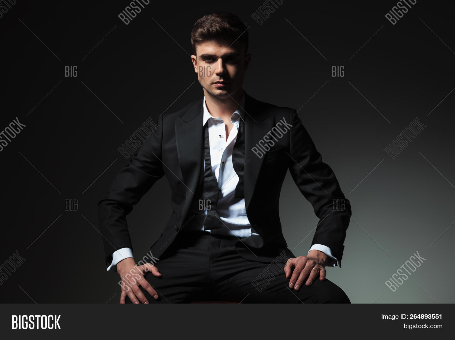 attractive,background,black,bow,bowtie,business,businessman,chair,collar,confident,dominant,elegant,fashion,formal,gentleman,grey,groom,hair,hands,handsome,happy,hold,look,male,man,open,people,person,portrait,powerful,relaxed,rest,seated,shirt,sit,smile,stool,stylish,suit,thighs,tie,tux,tuxedo,undone,untied,white,wood,wooden,young