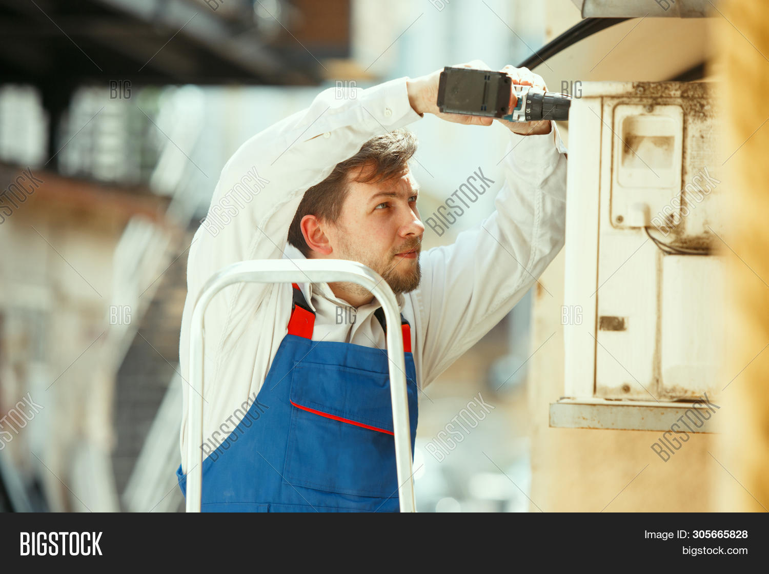 Hvac Technician Working On A Capacitor Part For Condensing Unit. Male