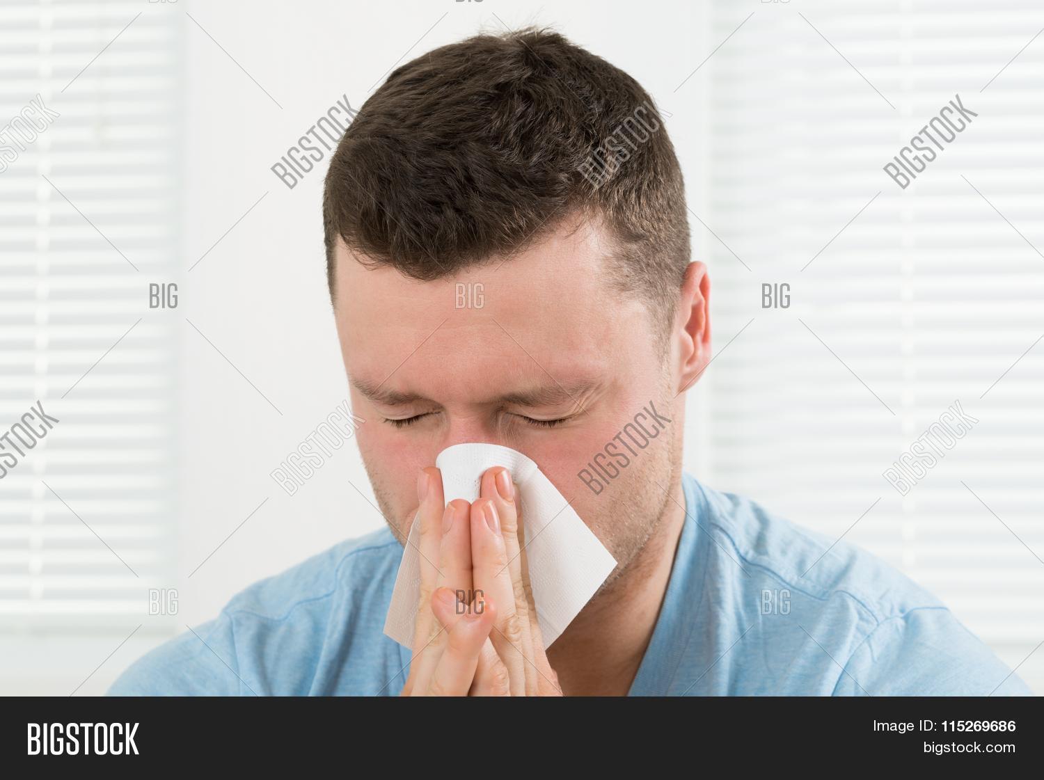 30s,adult,allergic,allergy,bacteria,blow,blowing,closed,closeup,cold,day,eye,face,fever,flu,hand,handkerchief,health,healthcare,holding,home,house,ill,illness,indoors,infection,influenza,lifestyle,male,man,men,mid,nose,one,people,person,sick,sickness,sneeze,sore,symptom,tissue,upset,virus,winter,wipe