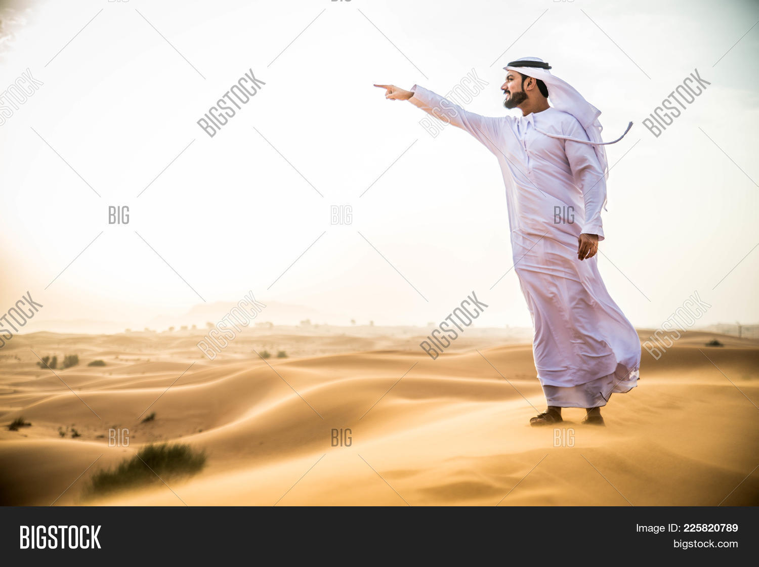 UAE,adult,alone,arabia,arabian,arabic,asia,away,clothing,concept,day,desert,dish-dasha,dishdash,dramatic,dry,dubai,dune,east,emirates,explore,far,gandoora,handsome,horizon,hot,kandora,landscape,looking,male,man,middle,middle-eastern,nature,one,outdoors,people,person,remote,robe,sand,standing,sun,sunlight,sunrise,sunset,traditional,walk,white,wilderness