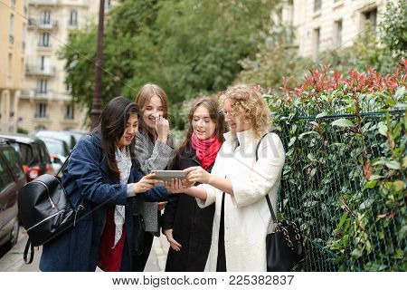 Chinese International Student Speaking With Teacher Outside In  . Concept Of Studying Abroad And Lea