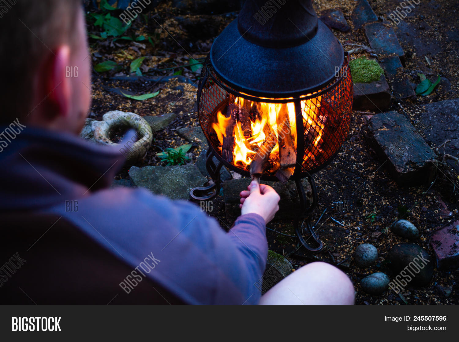 backyard,barbecue,bbq,burn,camp,campfire,camping,charcoal,coal,concept,conceptual,cooking,countryside,danger,energy,fire,fireplace,firewood,flame,food,glow,grilled,grilling,grills,heat,heating,hot,leisure,light,man,natural,nature,night,open,outdoor,red,roast,sitting,smoke,sparks,summer,twigs,warm,wilderness,wood,woodfire
