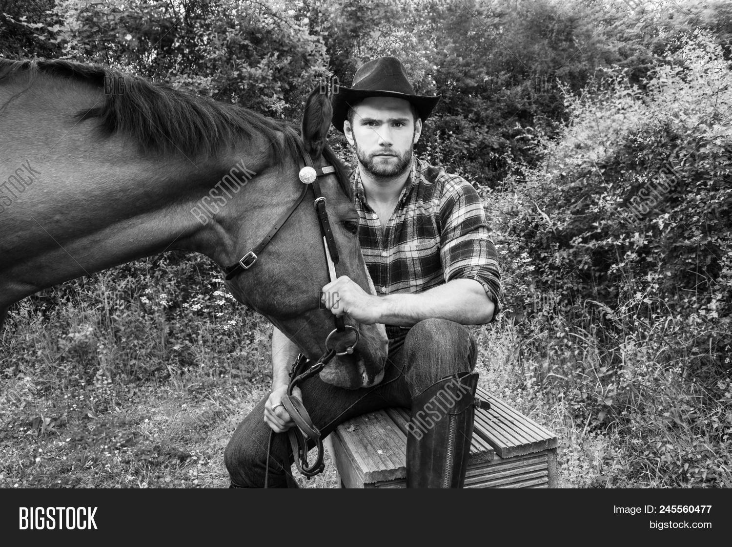 american,animal,beard,black,caucasian,chequered,colorado,country,cowboy,equestrian,equine,farm,farmer,farmhand,fence,green,guy,handsome,hat,horse,horseback,horserider,hunky,jeans,looking,macho,male,man,masculine,oklahoma,racehorse,ranch,rider,riding,saddle,shirt,sky,sport,stablehand,stallion,stetson,stud,summer,west,western,white,wire,wyoming,young