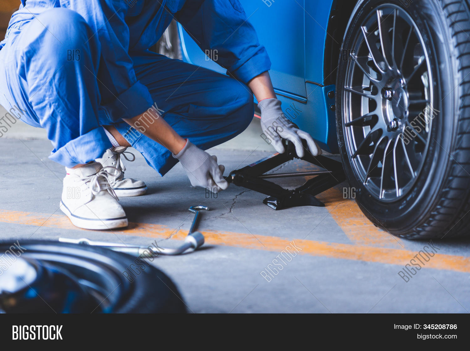 tire,tyre,mechanic,car,service,change,shop,garage,wheel,workshop,auto,holding,maintenance,tune,up,air,automobile,repair,winter,fix,vehicle,technician,man,worker,work,people,under,automotive,brake,center,motor,technology,business,disc,engineer,hands,inspection,check,mechanical,person,looking,fixing,machinist,road,travel,transportation,industry,jack,hydraulic,tool