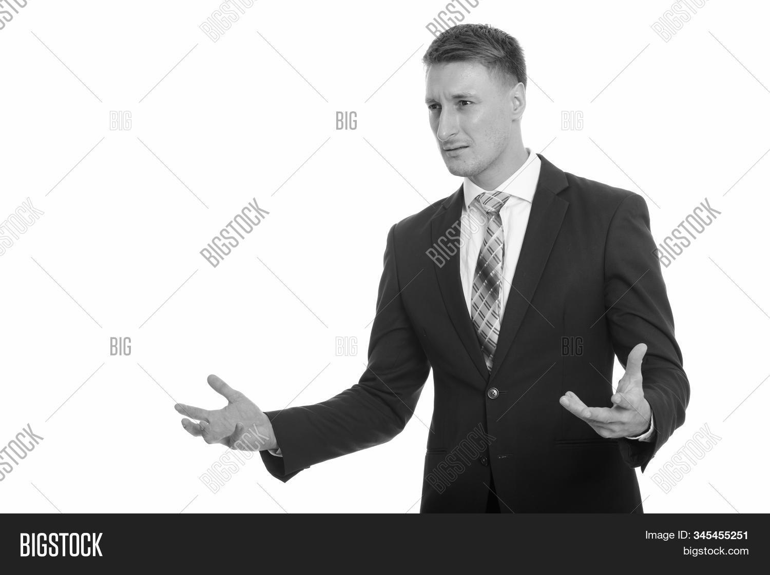 man,young,handsome,people,portrait,30s,adult,agitated,anger,arms,attractive,background,business,businessman,cool,executive,formal,irritated,isolated,looking,mad,one,person,problem,professional,raised,serious,single,success,successful,suit,work,worker,vintage,shadow,light,monochrome,white,black