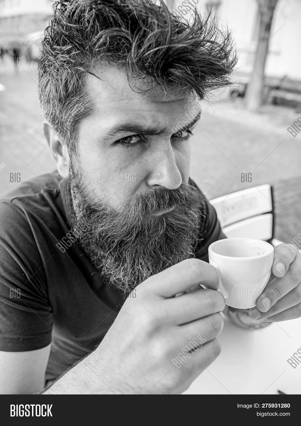 aroma,beard,bearded,beverage,break,cafe,cafeteria,caffeine,calm,cappuccino,casual,caucasian,client,coffee,concept,cup,diet,dieting,drink,energy,enjoy,espresso,face,guy,hair,handsome,have,health,hipster,hold,lunch,man,morning,mustache,outdoor,relax,rest,serious,strict,taste,terrace,town,unshaven,urban,visitor,while,young