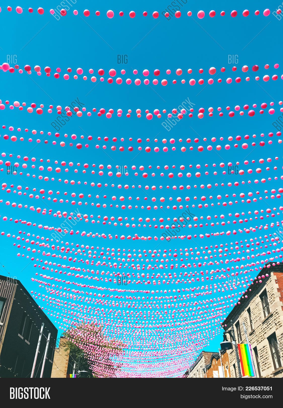 Canada,Catherine,Montreal,Quebec,Sainte-Catherine,Ste,Ste-Catherine,background,ball,balloon,blue,bright,building,city,clear,color,colorful,colour,colourful,decor,decorating,decoration,festival,festive,flag,hanging,homosexual,house,joyful,lgbt,line,outdoor,party,pink,pride,rainbow,red,sky,street,string,summer,symbol,town,urban,vertical,vibrant,village,vivid,wire