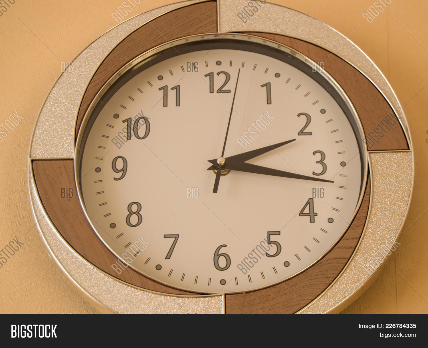 Round Wall Clock Shows The Time 2 Hours And 15 Minutes On Light