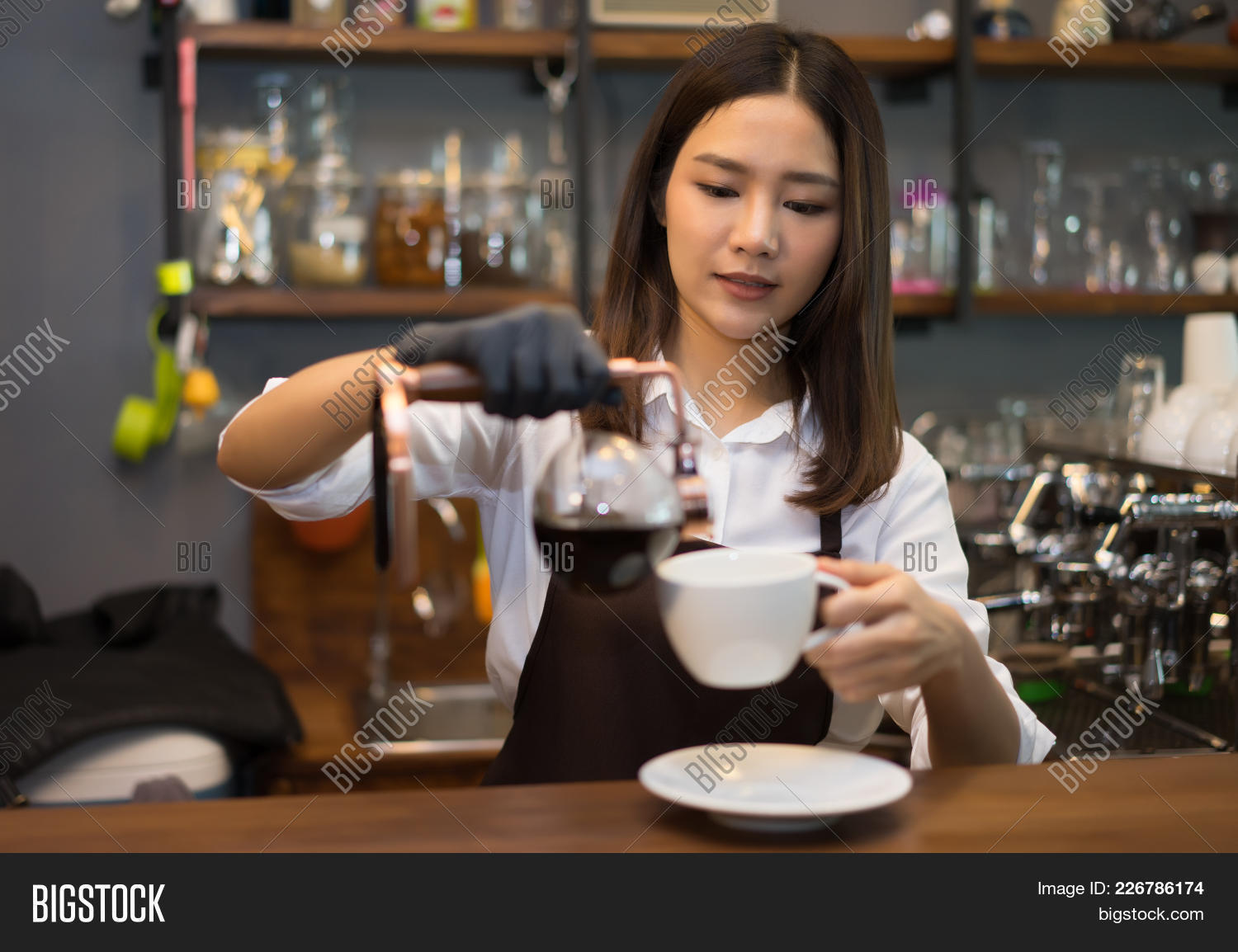 apron,attractive,bar,barista,beans,business,cafe,coffee,concept,counter,cup,drink,drip,employee,espresso,happy,ice,iced,labtop,latte,learning,machine,make,milk,notebook,owner,paddle,people,person,pour,preparing,professional,restaurant,service,shop,smiling,staff,syhon,uniform,waiter,waitress,woman,worker,young