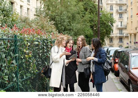 Chinese International Student Speaking With Teacher Outside In  . Concept Of Studying Abroad And Lea