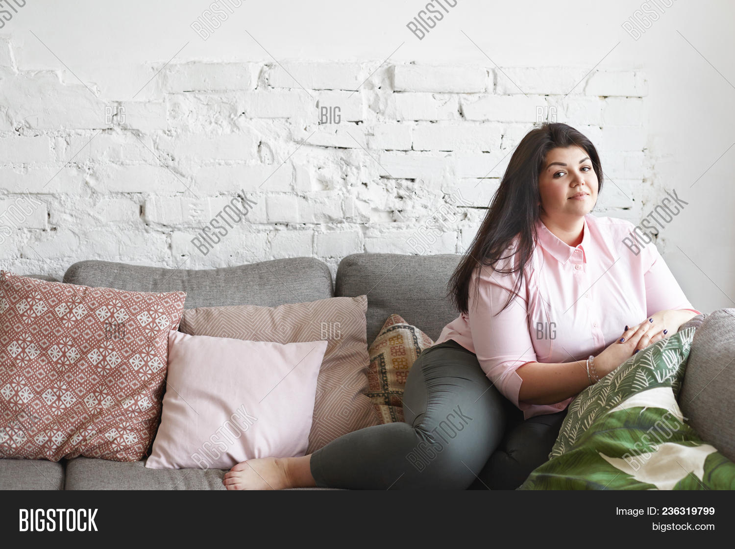 Happy Beautiful Young Plus Size Female With Loose Black Hair