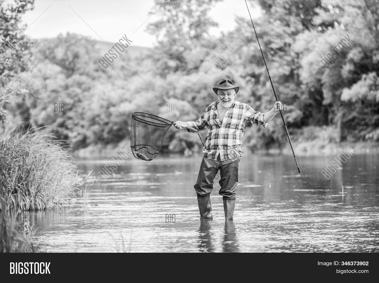 mature,man,retired,fisherman,fishing,rod,summer,weekend,trout,bait,bearded,fisher,hobby,sport,activity,pothunter,catching,fish,fly,river,stream,catch,nature,reel,closeup,animal,outdoor,wild,checkered,wilderness,traditional,twitching,hands,pond,ahi,pole,industrial,pro,action,equipment,line,freshwater,young,active,beard,hiking