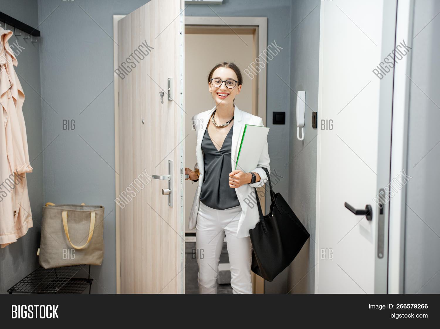 after,apartment,bags,caucasian,coming,corridor,door,doorway,enter,entering,entrance,female,flat,front,happy,home,indoors,job,lifestyle,one,open,opening,people,person,smiling,welcome,woman,young