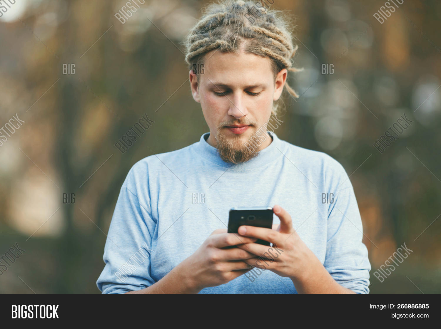 application,attractive,autumn,backpack,beautiful,boy,browsing,casual,caucasian,cellphone,charming,cheerful,clothing,concentrated,connection,dreads,feedback,forrest,hair,happy,hipster,leisure,lifestyle,man,message,music,nature,one,outdoor,people,person,portrait,positive,school,smartphone,smile,student,transfer,travel,vacation,wifi,wood