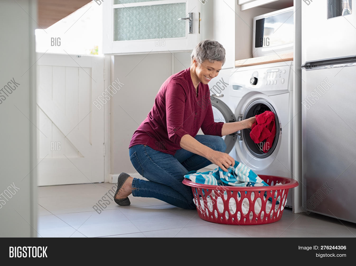 50s,60s,appliance,basket,casual,chores,clean,cloth,clothes,clothing,crouching,daily,dirty,dirty clothes,dryer,gray hair,happy,home,house work,household,housekeeper,housekeeping,housewife,housework,hygiene,indoors,kneeling,laundering,laundry,laundry basket,loading,machine,mature,matured,mid adult woman,middle aged woman,old woman,people,putting,routine,senior,senior woman,smile,toothy smile,washer,washing,washing machine,wife,work