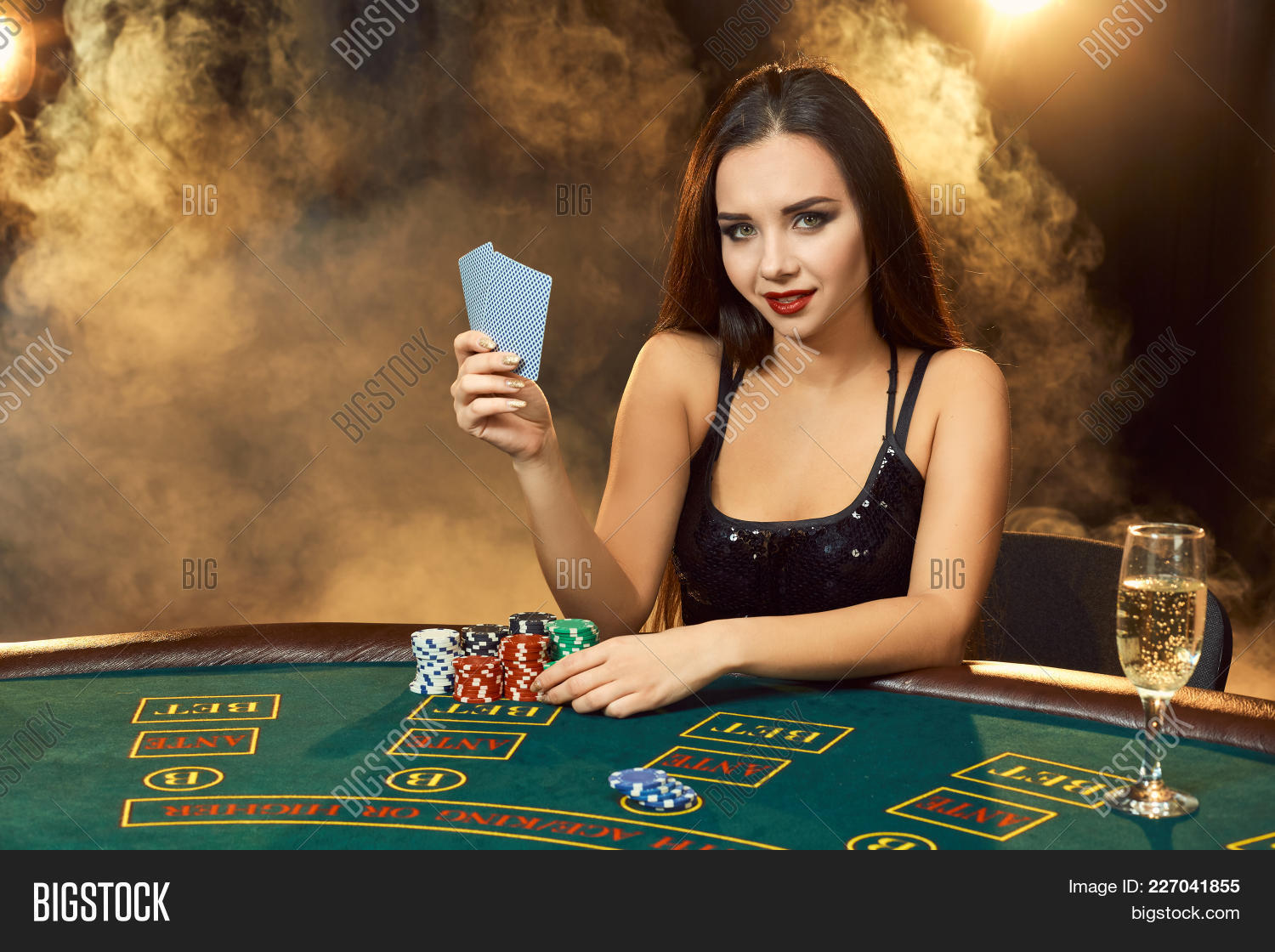 Gorgeous Emotional Young Woman In A Black Dress Sitting At Poker Table With Glass Of Champagne Let Image Stock Photo 227041855 If the table is full they will take your initials and call you when there is an opening. young woman in a black dress sitting