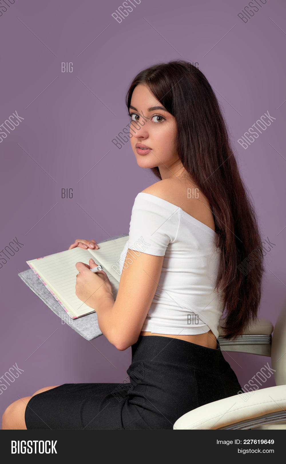 activity,adult,asian,attractive,back,background,beautiful,book,bright,brunette,businesswomen,classic,clothing,college,color,concept,education,female,folder,girl,hands,hold,holding,isolated,knowledge,looking,notebook,pen,people,person,portrait,professional,purple,school,sitting,student,studio,study,studying,swarthy,textbook,thoughtful,university,vertical,white,woman,women,write,young