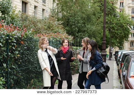 Chinese International Student Speaking With Teacher Outside In  . Concept Of Studying Abroad And Lea