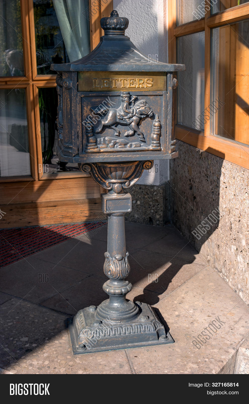 Old Black Metal Mailbox On A Metal Base. The Bas-relief Is Made On The ...
