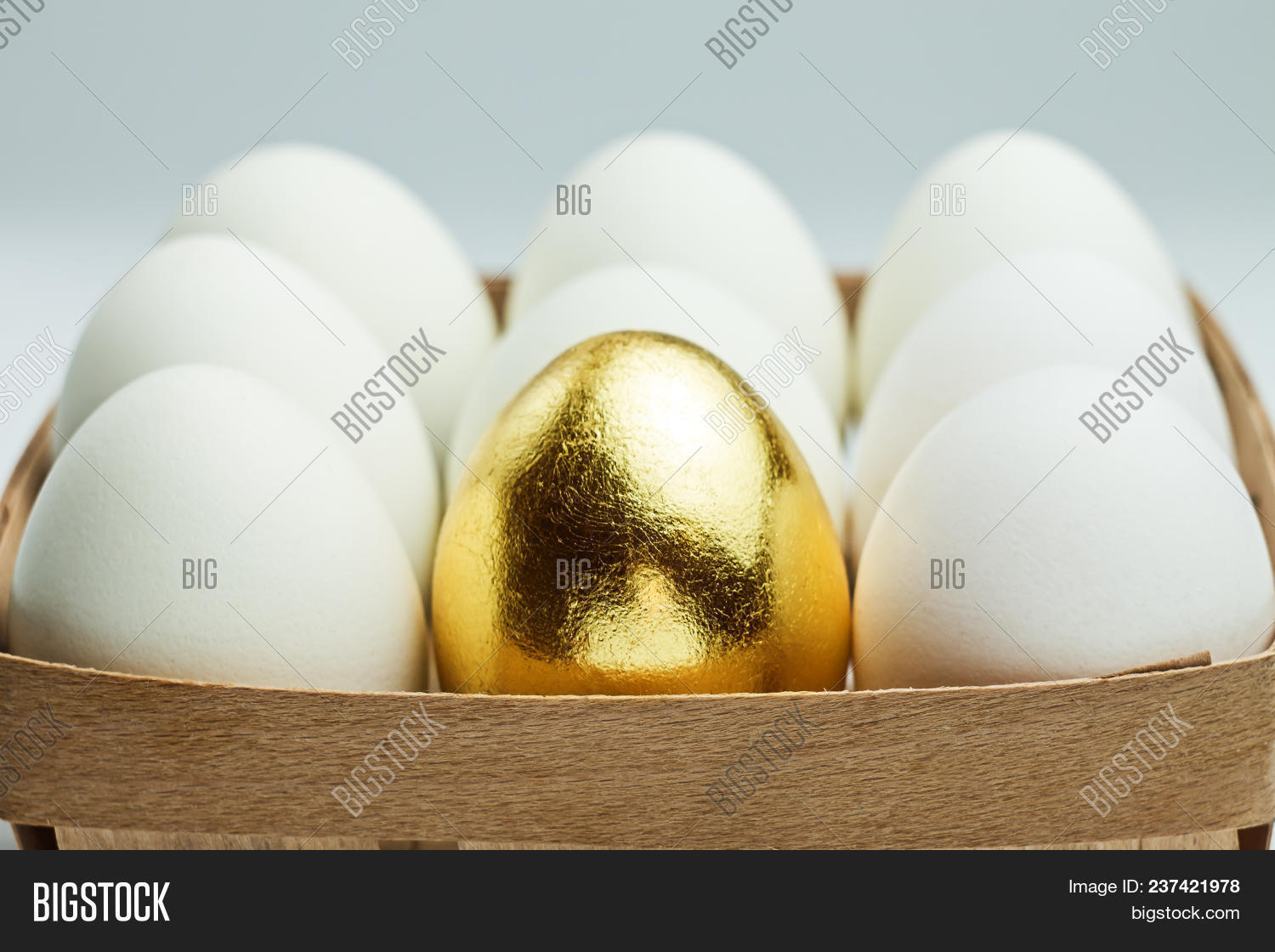 One Golden Egg Among White Eggs In A Wooden Box Uniqueness Concept Image Stock Photo