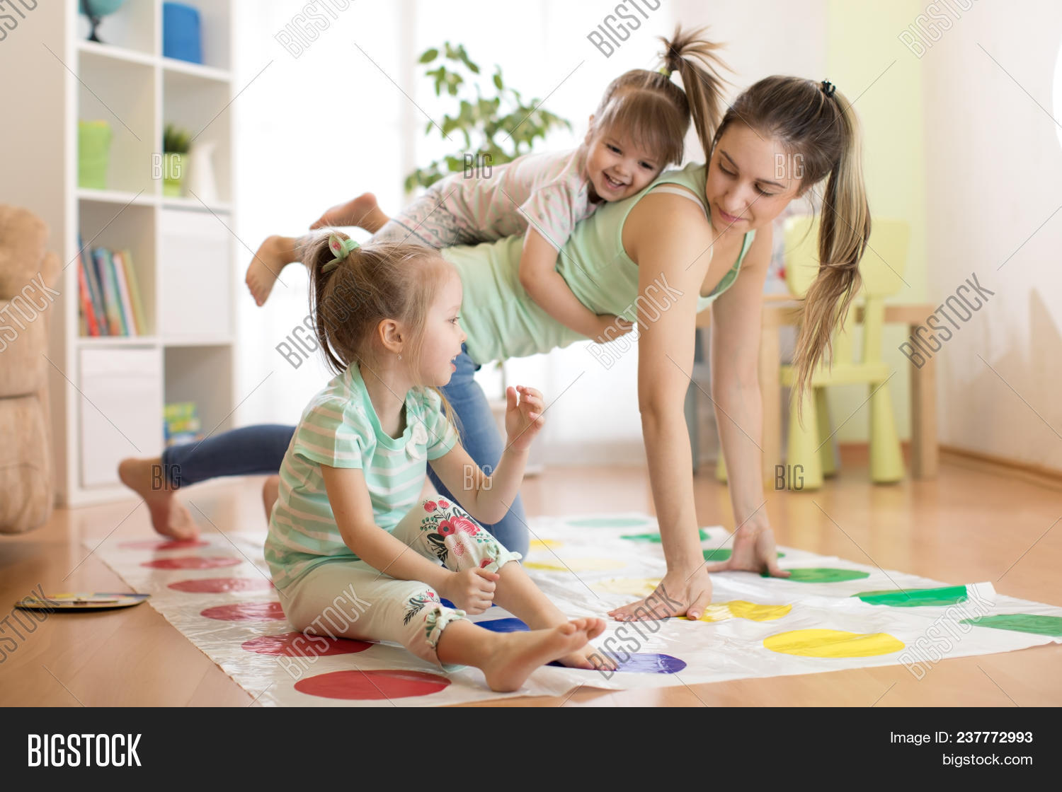activity,adult,care,cheerful,child,childhood,children,daughter,day,emotional,expression,family,female,floor,fun,game,girl,hands,happy,having,home,indoors,inside,interior,joy,joyful,kid,laughing,legs,leisure,living,loving,mom,mother,motion,mum,mummy,parent,parenthood,playing,room,sister,smiling,sofa,together,togetherness,twister,weekend,woman