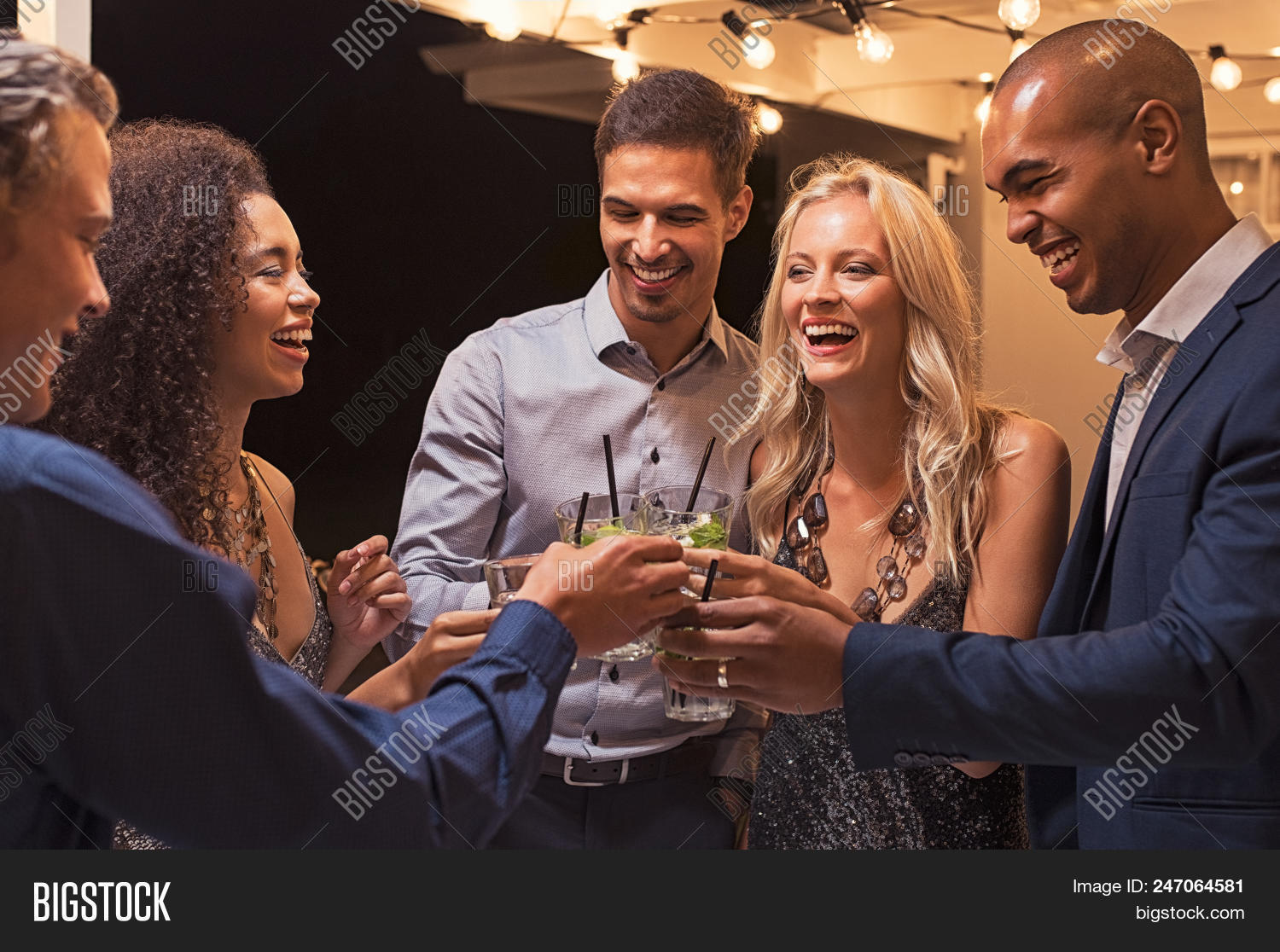 alcohol,beverage,black,celebrate,celebrating,celebration,cheer,cheerful,clinking,cocktail,couple,drink,elegant,enjoyment,event,friend,friends,friendship,fun,girl,group,guy,happy,joy,laughing,lifestyle,lightbulb,man,men,mojito,multiethnic,night,outdoor,party,patio,people,smiling,stylish,toast,toasting,together,woman,women