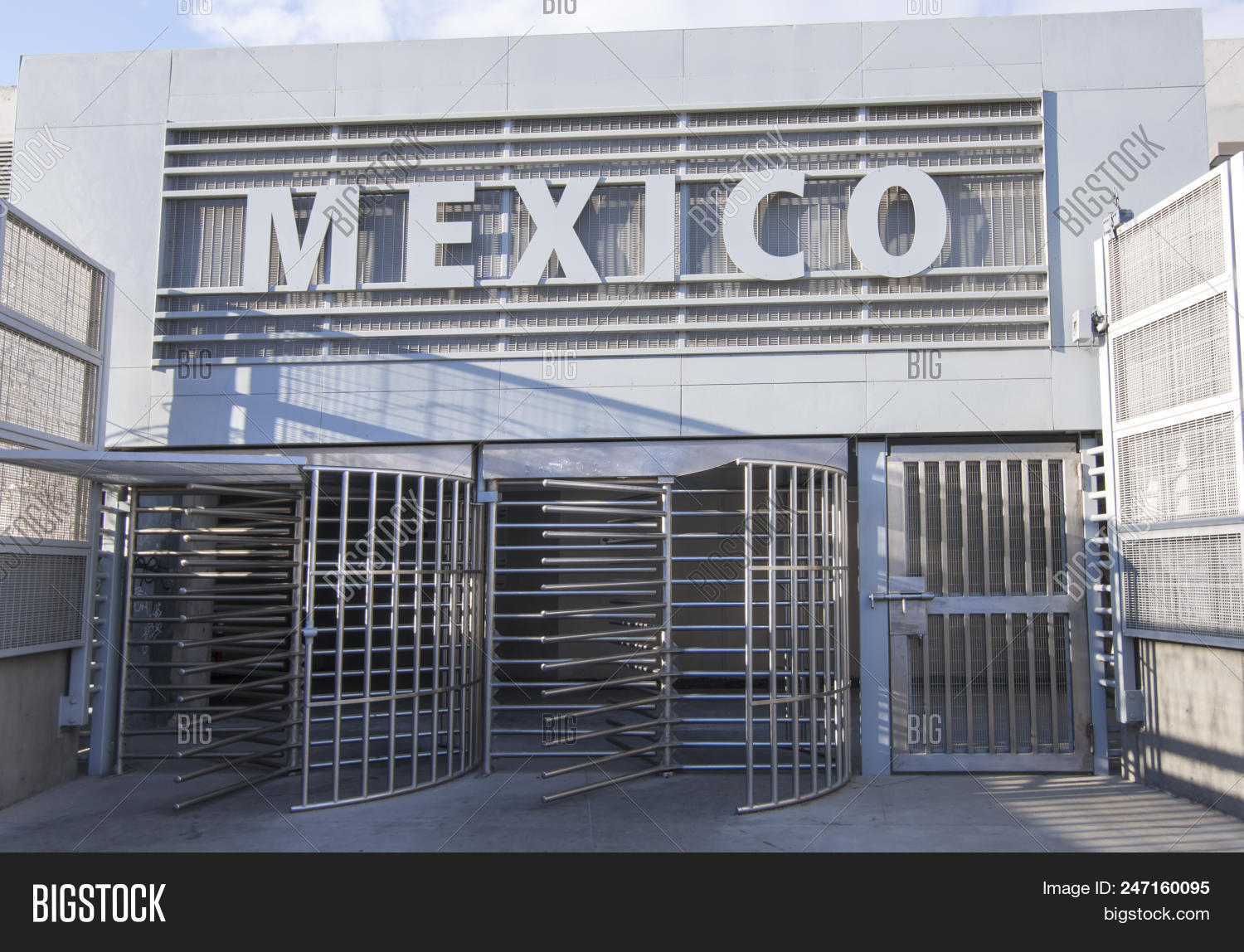 California,Mexico,San,Tijuana,Ysidro,border,crossing,day,destination,door,entry,gate,horizontal,international,morning,no,outside,passage,pedestrian,people,political,revolving,sign,sunny,travel,turnstile,walkway,wall