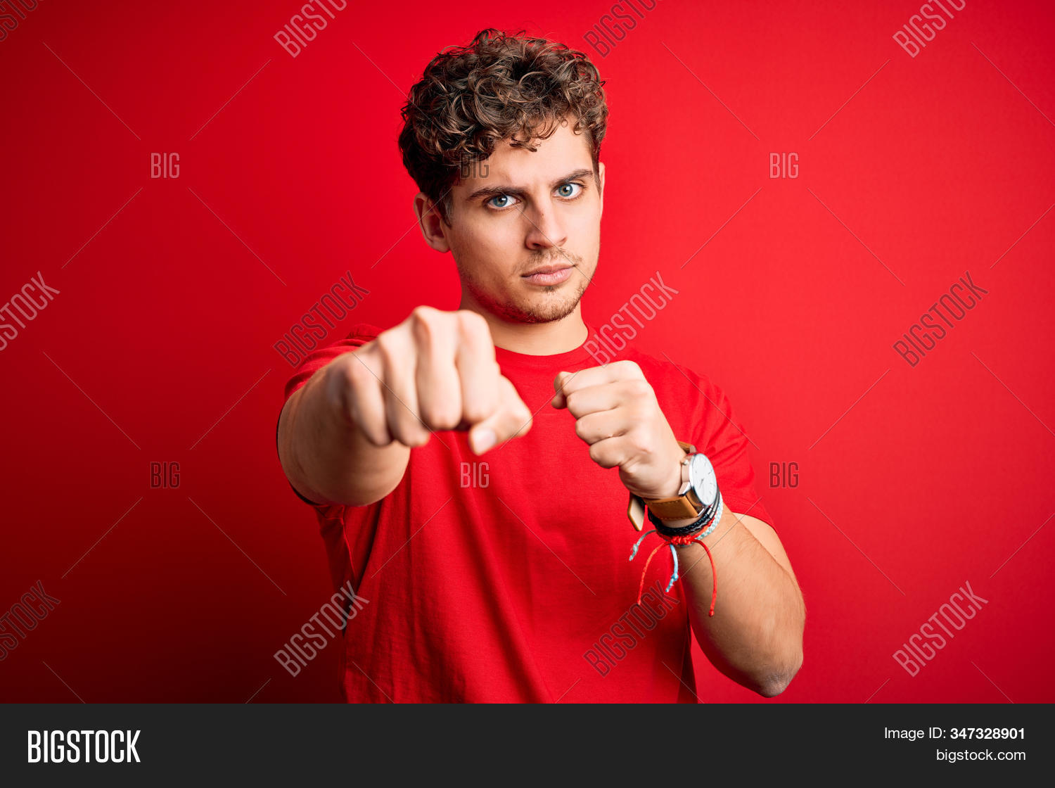 adult,aggression,aggressive,anger,angry,arm,assault,attack,attractive,background,blond,boxing,casual,caucasian,clenched,conflict,cool,curly hair,expression,fashion,fight,fist,force,gesture,hand,handsome,hit,isolated,man,model,negative,person,portrait,power,punch,red,sign,standing,strength,strike,strong,studio,summer,symbol,t-shirt,threat,tough,victory,violence,young
