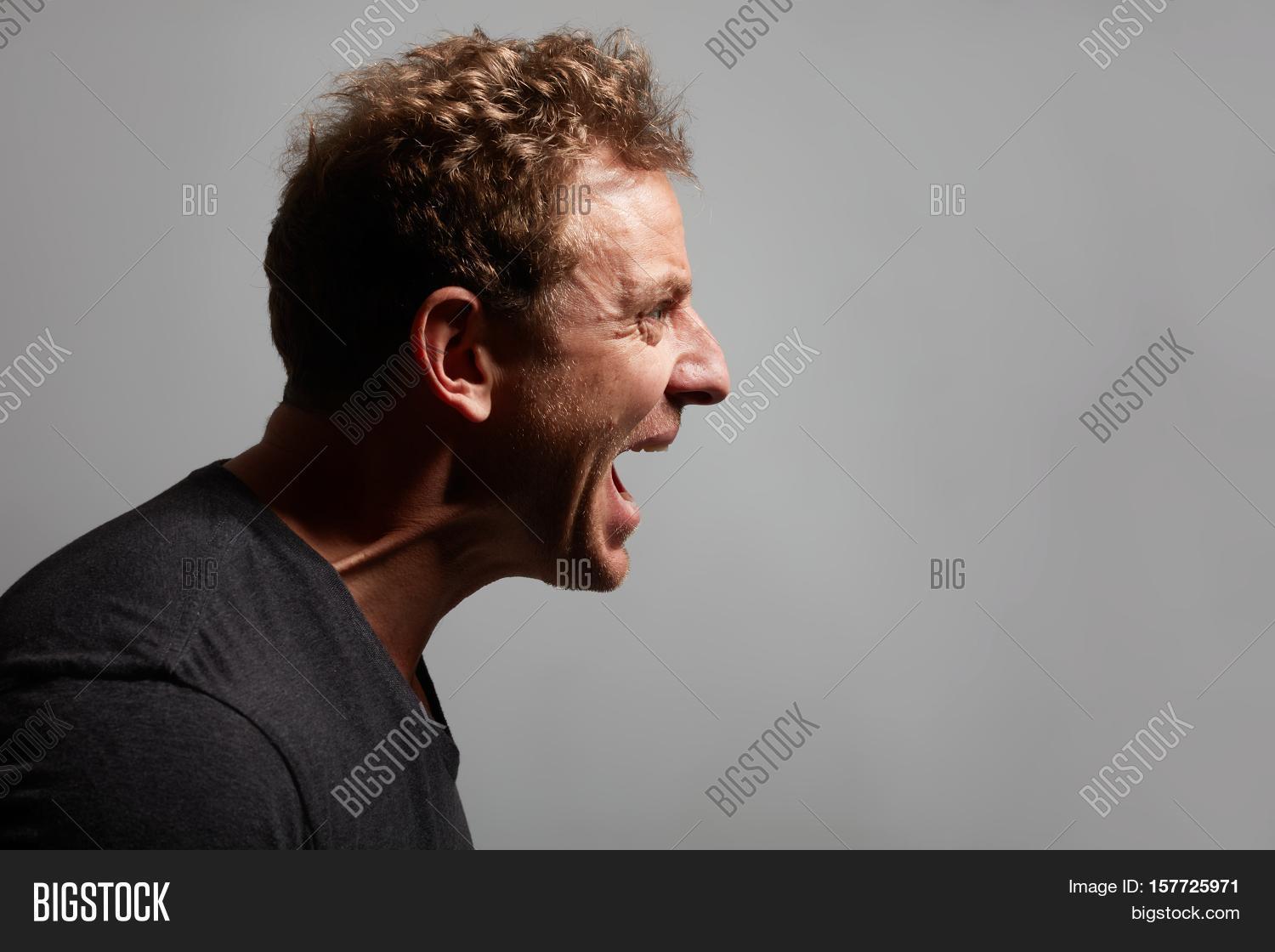 30,40,adult,anger,angry,appearance,background,banner,boy,casual,caucasian,close-up,dark,emotion,expressions,face,feeling,fury,gray,grumpy,guy,head,human,irate,ire,lifestyle,look,male,man,mind,one,person,portrait,profile,rage,rampage,wall,worth,wrath,young