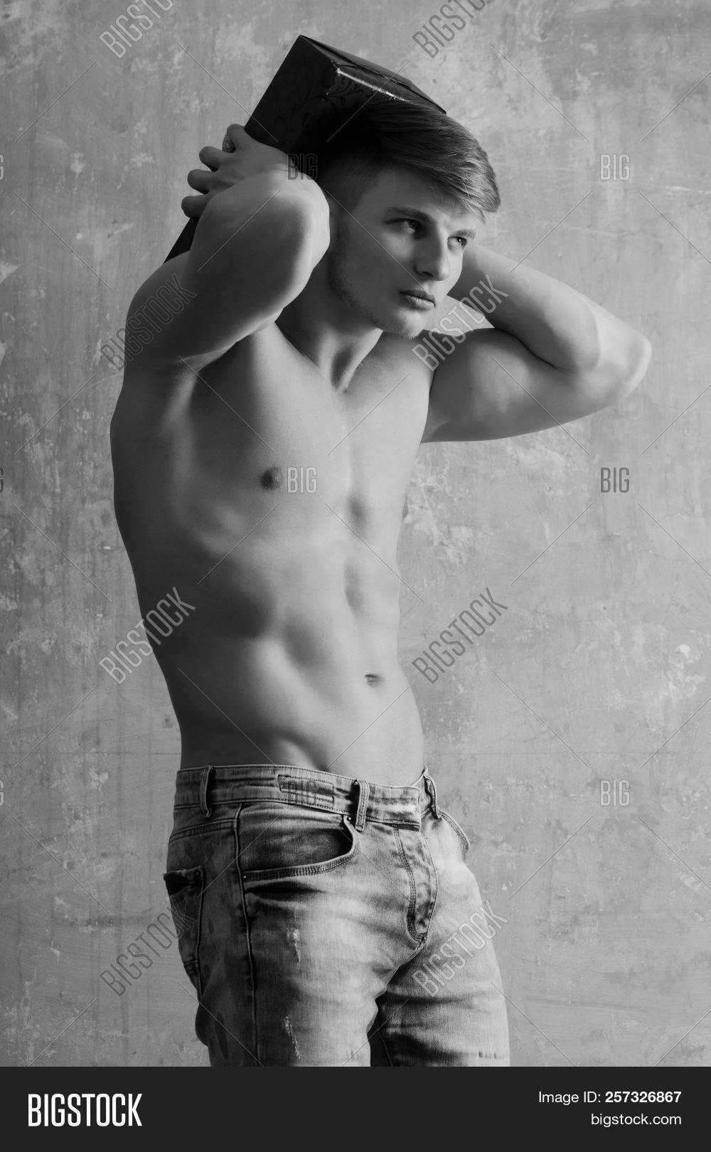 ab,arms,athlete,athletic,beige,belly,biceps,birthday,blue,bodybuilder,box,caucasian,celebration,chest,christmas,day,energetic,energy,fit,fitness,gift,gym,handsome,holding,holiday,jeans,macho,man,muscle,muscular,naked,pack,package,present,red,six,sport,strong,torso,training,triceps,valentine,wall,workout