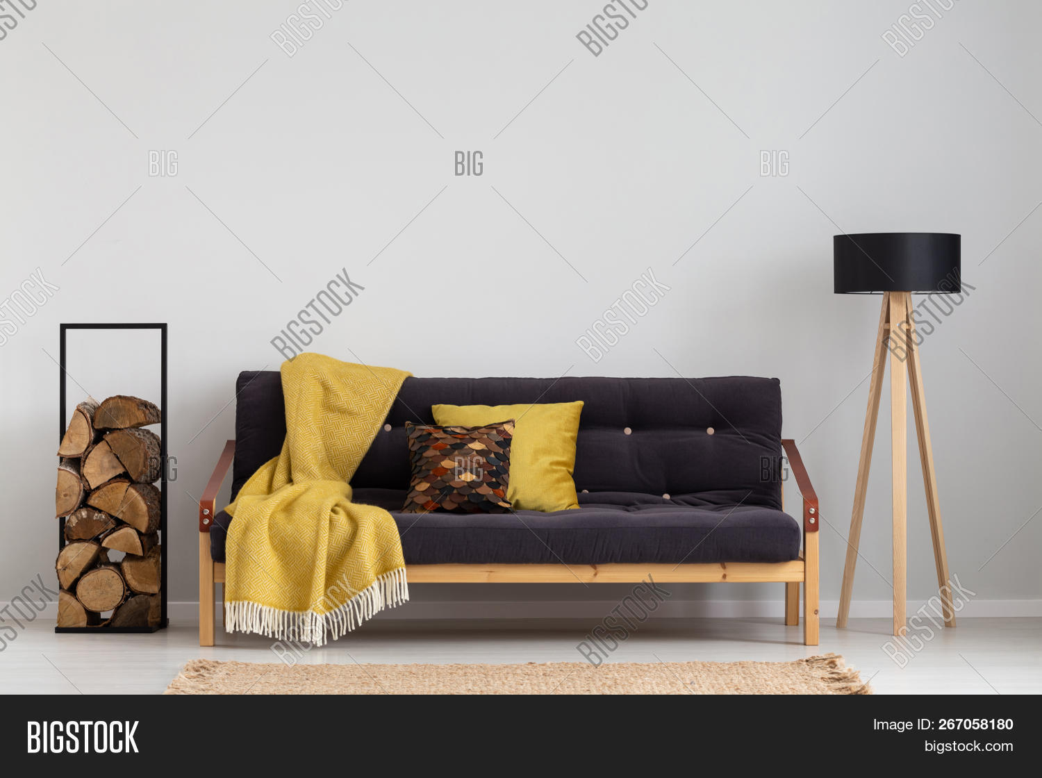 Log Of Wood Next To Comfortable Sofa With Yellow Blanket And