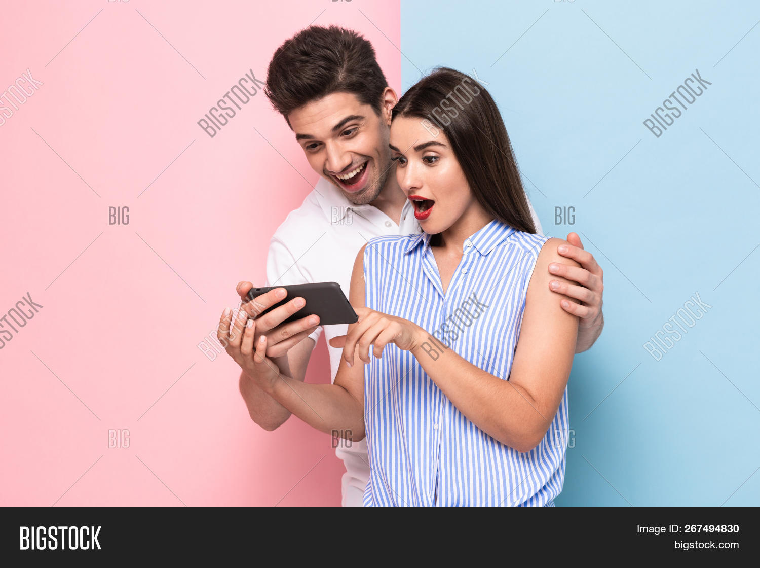 30s,adult,attractive,background,boy,brunette,casual,caucasian,cell,cheerful,colorful,couple,emotions,female,girl,guy,half,handsome,happy,holding,indoor,isolated,joyful,male,man,mobile,optimistic,phones,photo,portrait,posing,positive,smartphones,smile,studio,t-shirt,together,using,wall,woman,young