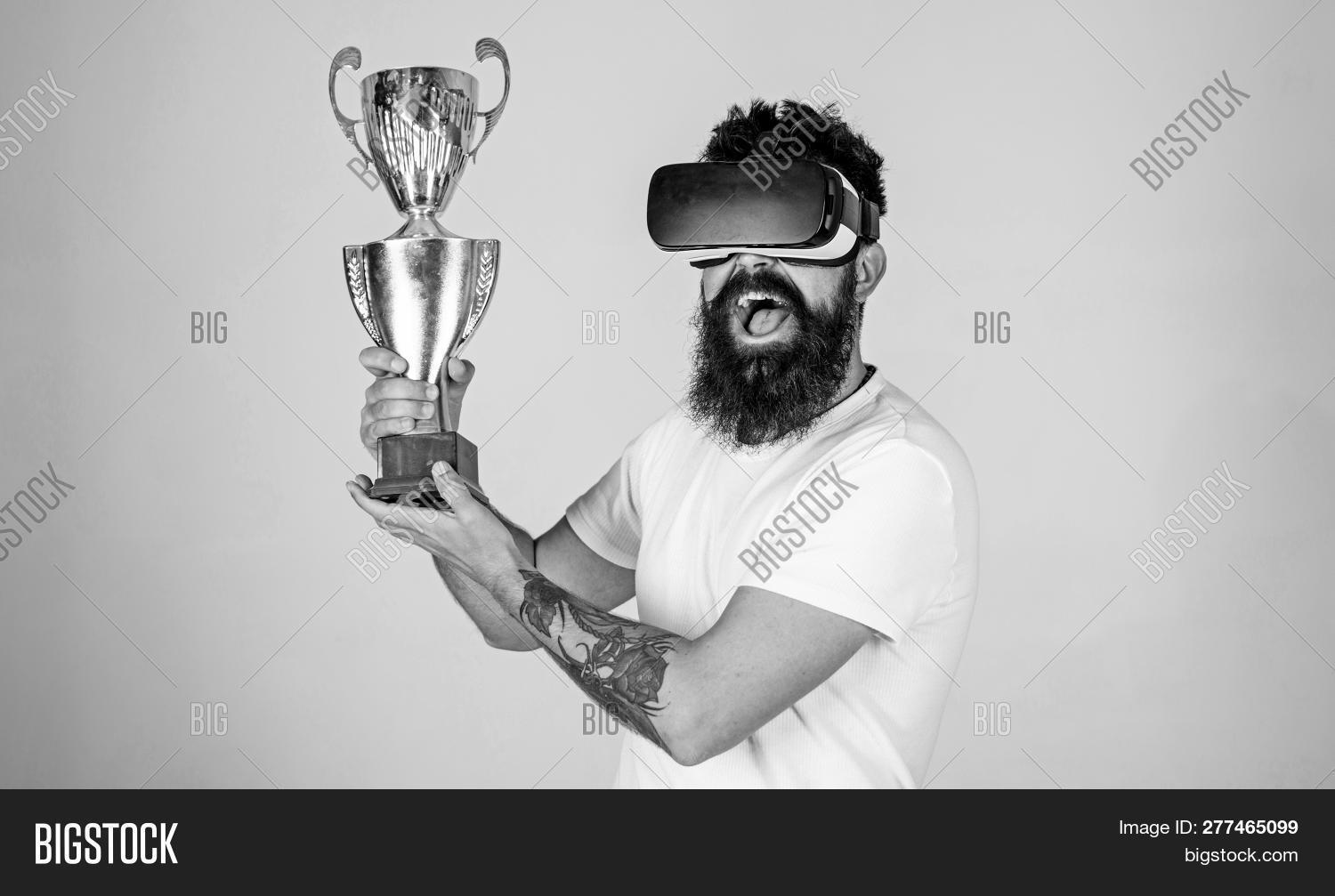 1st,3d,background,beard,bearded,champion,championship,cheerful,computer,cup,cyber,device,digital,first,gadget,game,gamer,glasses,goggles,gray,handsome,happiness,happy,headset,hipster,innovation,interface,isolated,joy,joyful,man,modern,mustache,online,play,pose,simulation,sport,stylish,tattoo,technology,tournament,trendy,victory,virtual,vr,win,young