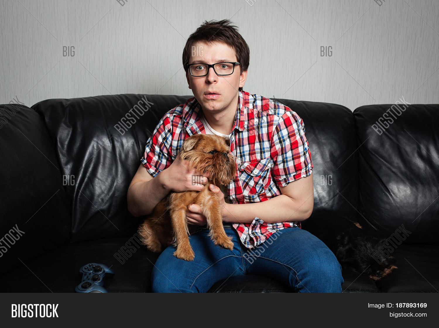 Closeup Portrait Young Man In The Red Shirt Sitting On Black