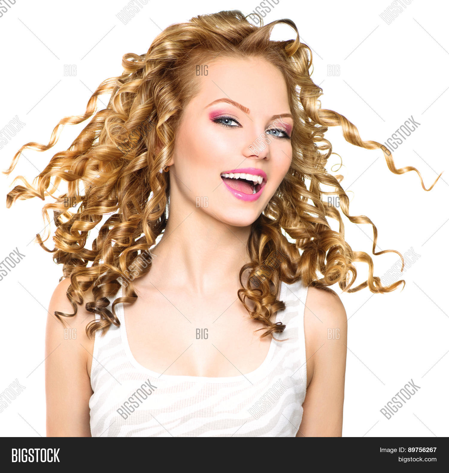Beauty Model Girl With Blowing Blonde Curly Hair Portrait