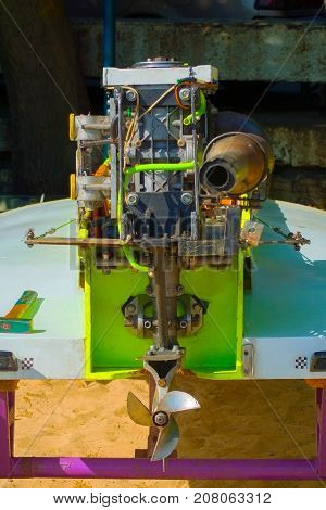 on ashore close-up of an outboard for a racing boat repair preparation ...