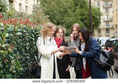 Chinese International Student Speaking With Teacher Outside In  . Concept Of Studying Abroad And Lea