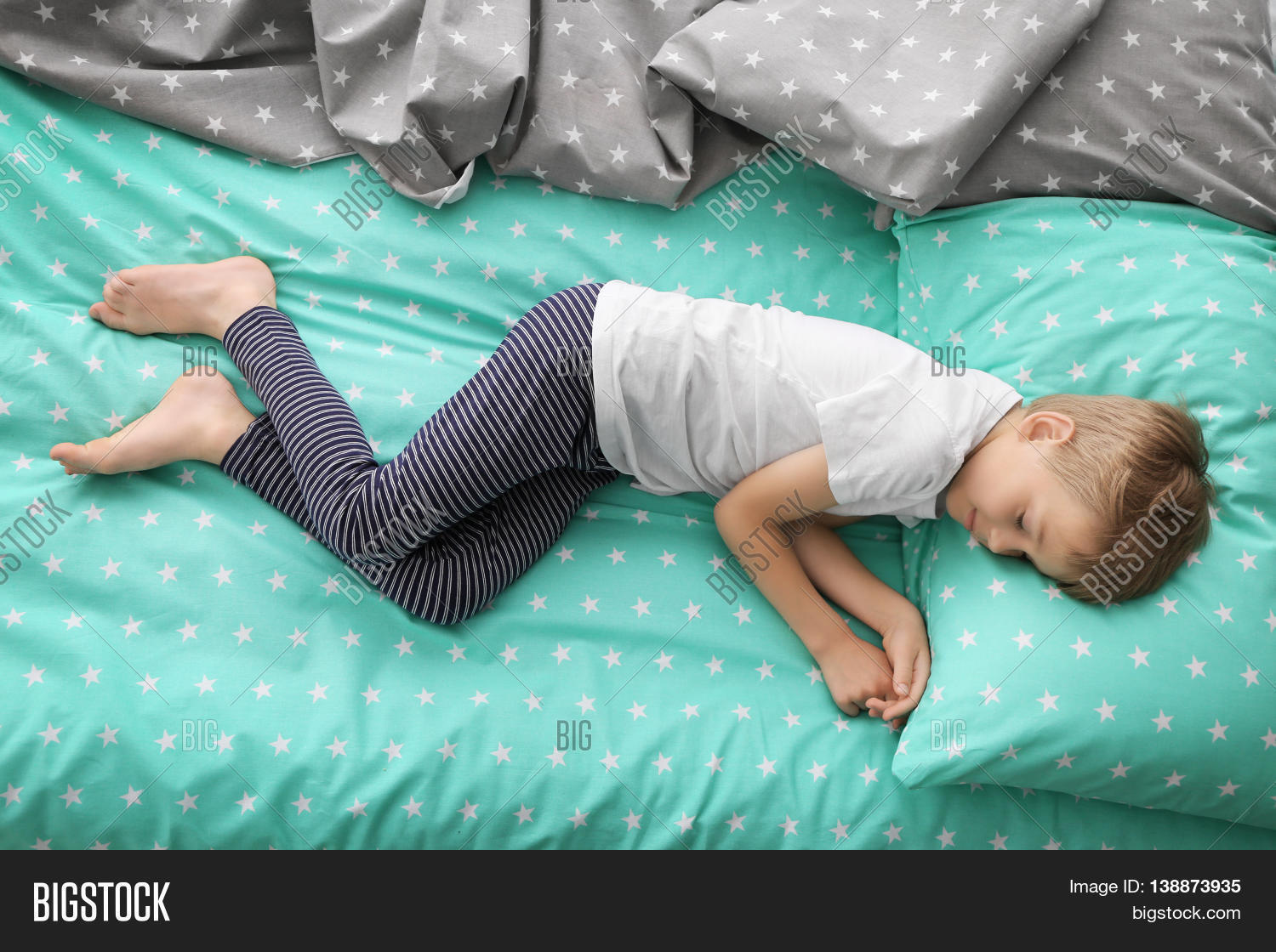 adorable,afternoon,arm,asleep,background,bed,bedclothes,blue,boy,care,carefree,caucasian,child,childcare,childhood,cute,dream,fallen,hand,health,healthy,human,innocence,kid,lay,light,linens,little,lying,morning,panties,person,pillow,preschool,rest,sheet,shirt,sleep,star,striped,time,top,view,white