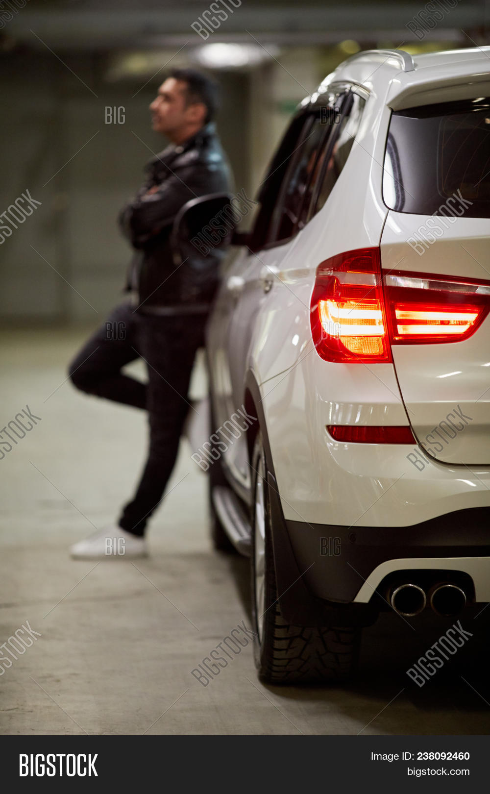 auto,automobile,back,black,car,contemporary,control,device,dof,door,driver,editorial,engine,equipment,focus,garage,hood,key,lean,light,lock,male,man,modern,motors,one,owner,parking,person,power,protection,remote,security,shallow,side,space,stand,steer,system,taillight,transport,underground,vehicle,wheel,white