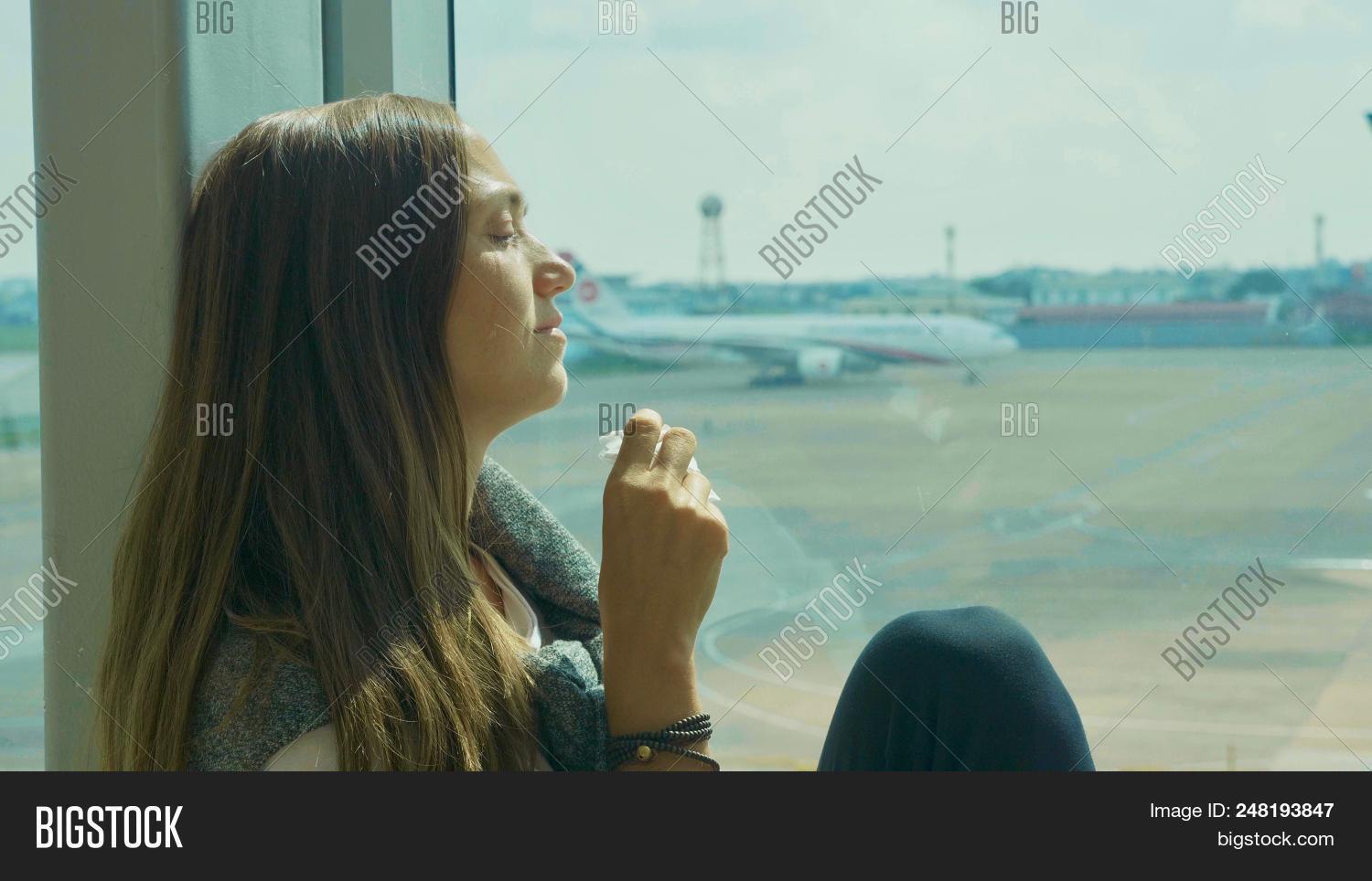 airplane,airport,alone,away,background,casual,concept,crying,departure,disorder,female,flight,girl,handkerchief,holding,lifestyle,looking,napkin,passenger,person,plane,sad,sill,sitting,teardrop,tears,terminal,tourist,transportation,travel,traveler,trip,upset,vacation,waiting,window,windowsill,wipes,woman,women,young