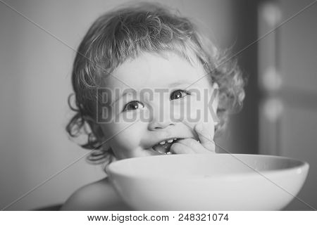 Child Eats Porridge Portrait Of Sweet Little Laughing Baby Boy