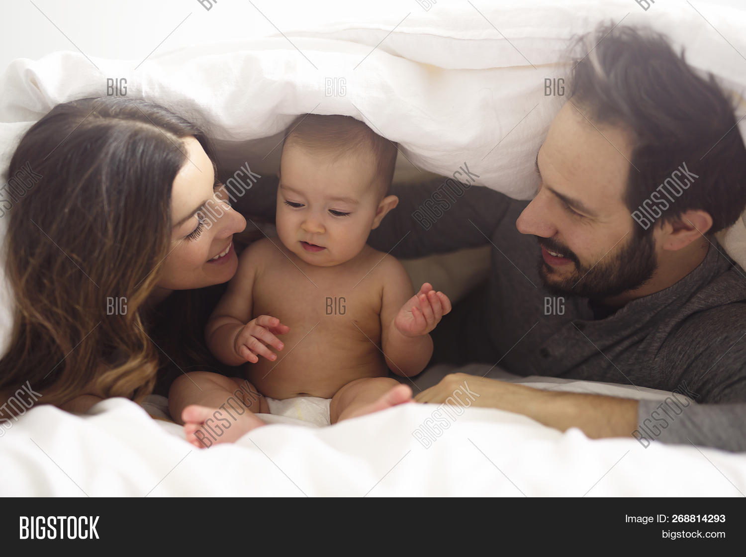 abode,apartment,baby,bed,bedroom,blanket,bonding,casualclothing,caucasian,comfortable,content,couple,daughter,domesticlife,family,familywithonechild,father,female,frontview,girl,happiness,holding,home,homey,house,household,indoors,leisure,lifestyle,love,lyingdown,male,man,mother,parent,relationship,relax,relaxation,sheet,togetherness,twoparents,youngadult
