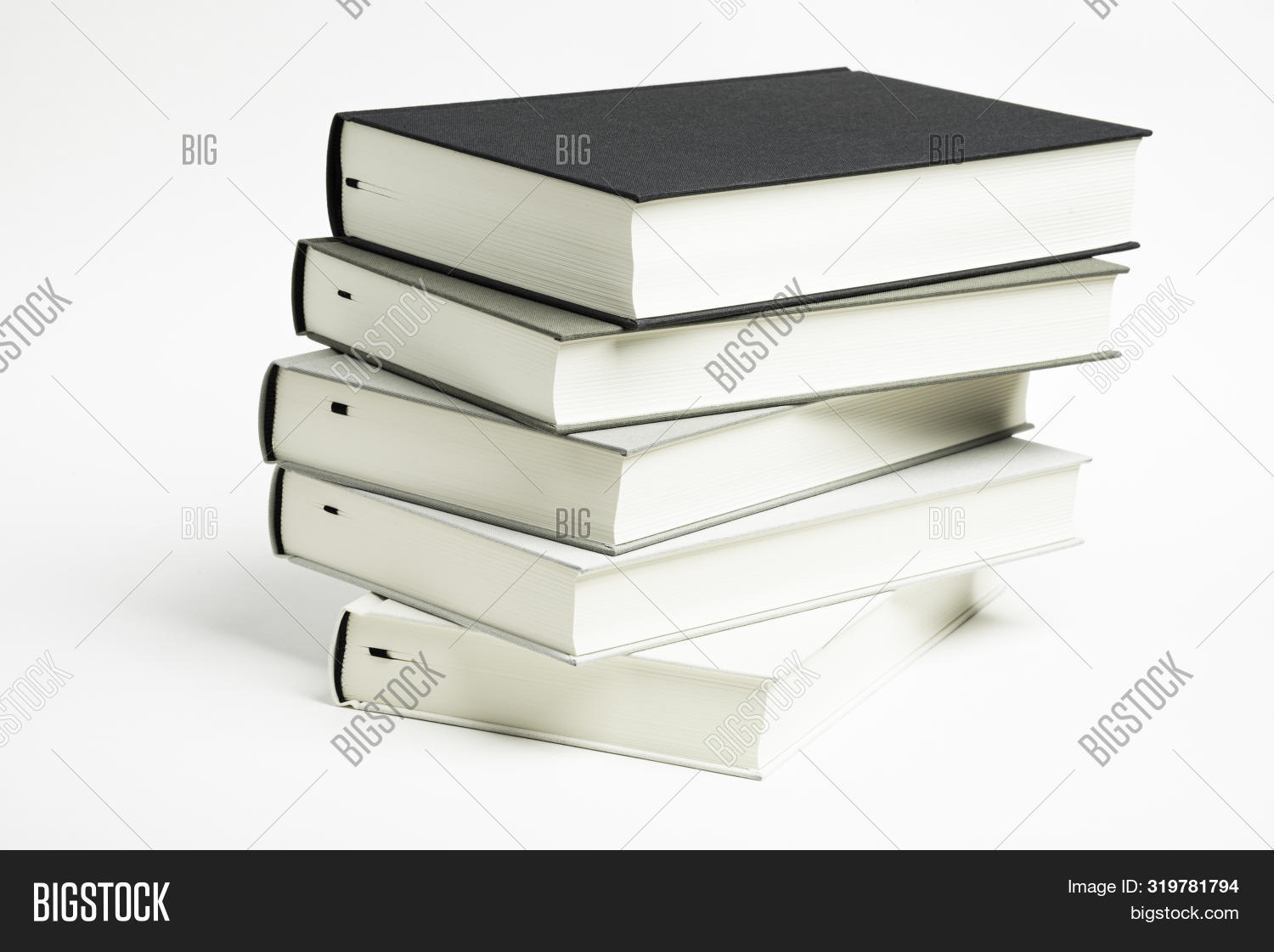 A Disarrayed Stack Of Five Monochromatic Cloth Bound Books Set On A ...