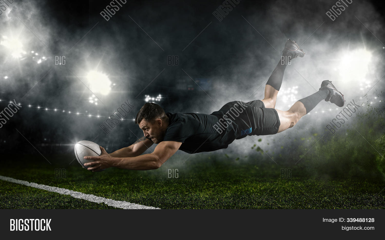 action,activity,aggression,arena,athlete,background,ball,black,brave,competitive,dark,event,field,floodlight,football,game,goal,handsome,healthy,hero,hit,jump,kick,lawn,male,man,match,mud,muscular,outdoors,player,playing,professional,rugby,sky,smoke,sport,sportsman,stadium,team,try