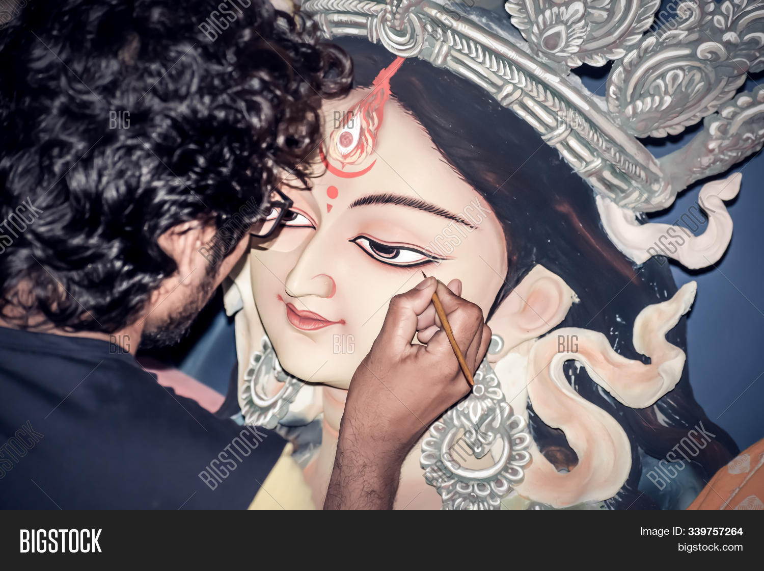 Human-hand,acrylic,adult,art-and-craft,artist,backgrounds,beauty,brush-stroke,canvas,clay,close-up,color,craftsperson,creation,creative,creativity,design,drawing-product,durga,expertise,eye-make-up,festival,glamour,god,hindu-goddess,hinduism,idol,indian-culture,indoors,making-a-face,man-only,occupation,one-person,paintbrush,painter,painting-activity,palette,people,portrait,preparation,puja,sculptor,sculpture,skill,statue,studio-workplace,tradition,working,workshop,young