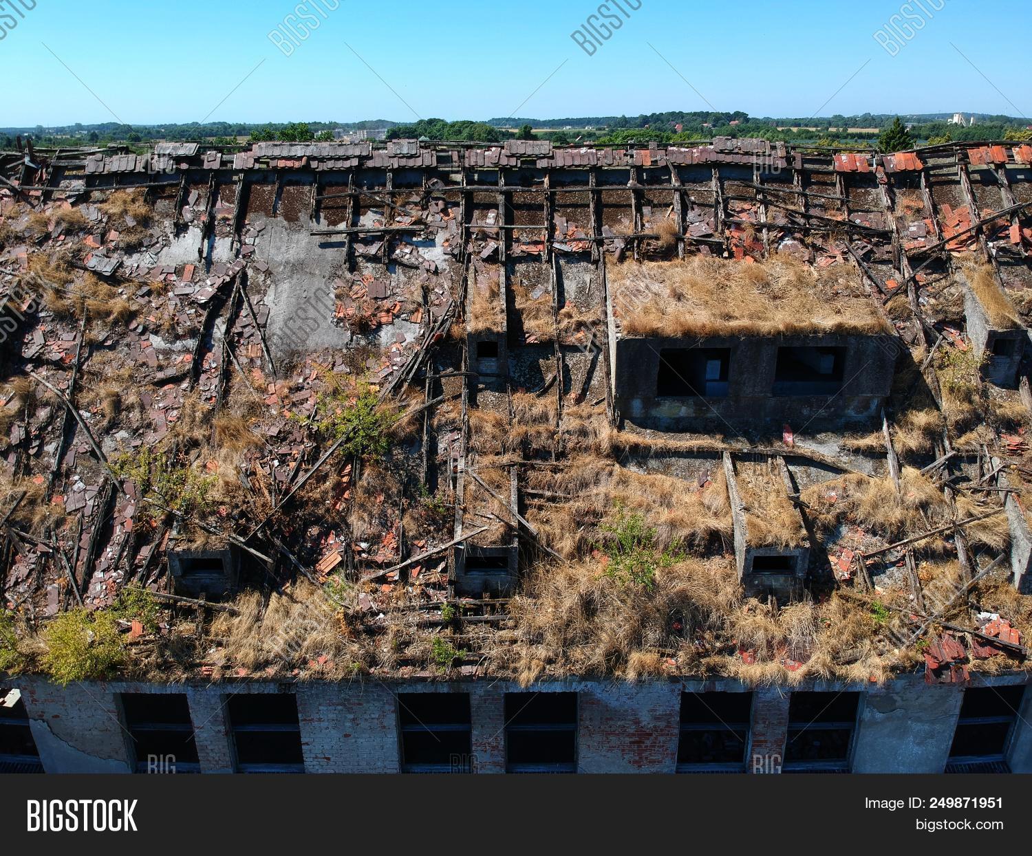 abandoned,above,aerial,apocalypse,architecture,broken,building,by,concrete,construction,danger,demolished,demolition,destroyed,drone,empty,grass,industrial,old,roof,ruined,structure,top,trees,urban,view