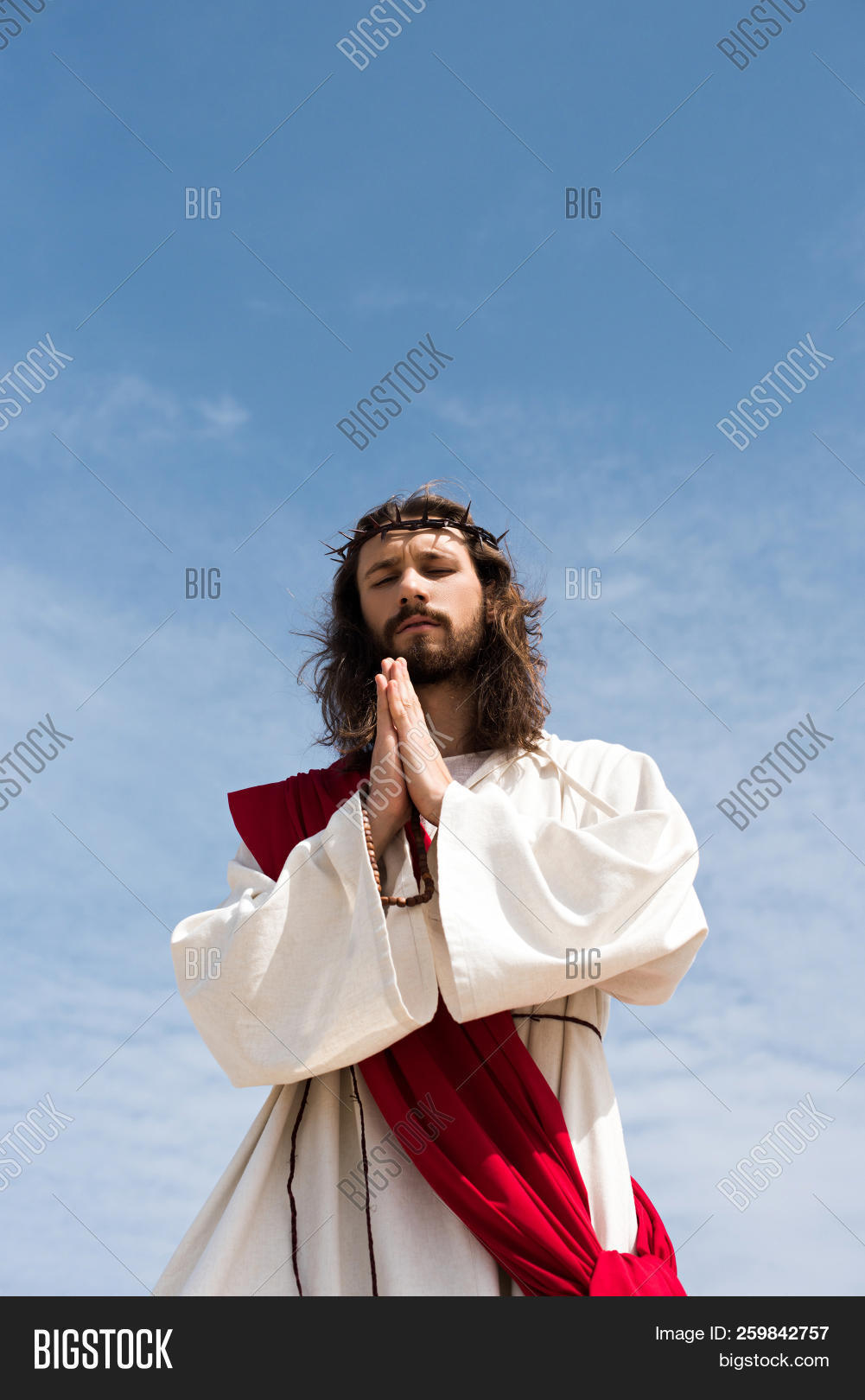 adult,almighty,alone,angle,blue,catholic,caucasian,christ,christianity,closed,copy,crown,eyes,god,hair,hands,handsome,history,holding,holy,israelite,jehova,jesus,long,lord,low,male,man,namaste,of,outdoors,people,person,pray,praying,red,religion,religious,robe,rosary,sash,sky,space,standing,thorns,view,yeshua,young
